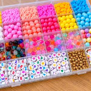 Close-up of assorted colorful beads and unicorn charms